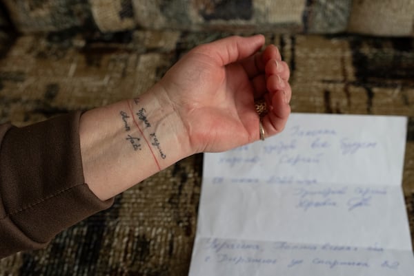 Halyna Hryhorieva of Pyriatyn, Ukraine, shows her tattoo of words often spoken by her husband, who was a prisoner of war in Russia: "Everything will be all right," on March 9, 2025. (AP Photo/Alex Babenko)