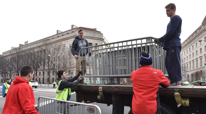 Volunteers and staff set up barricades Thursday in Washington as the city prepares for Friday’s inauguration of Donald Trump as president. HYOSUB SHIN / HSHIN@AJC.COM