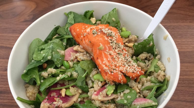 Upbeet’s Oh-Mega grain bowl includes brown rice, quinoa, spinach, edamame, hemp seeds, cashews, watermelon radishes and other tasty tidbits, but the star is the slab of sustainable steelhead trout. CONTRIBUTED BY WENDELL BROCK
