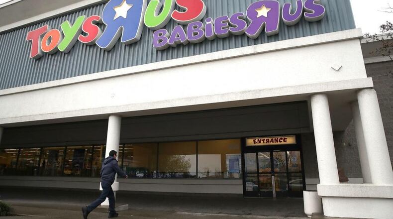 A customer enters a Toys R Us store. The iconic company filed for liquidation in March in a U.S. Bankruptcy court and plans to close 735 stores leaving 33,000 workers without employment.