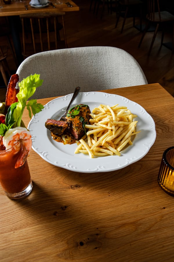 Steak frites served at brunch with a bloody mary at Brasserie Lundi in Midtown. (Courtesy of Hospitality HQ)