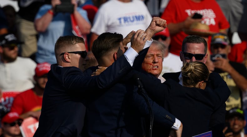 Former President Donald Trump is whisked away by Secret Service after shots rang out at a July 13 campaign rally in Butler, Pa. (Jeff Swensen/Getty Images/TNS)