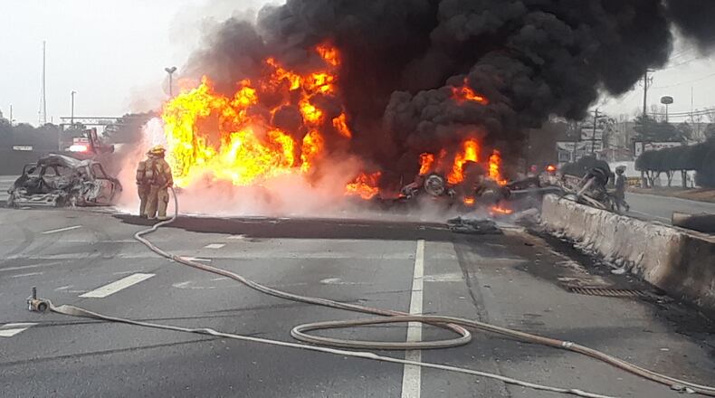Two people died in a fiery crash on I-85 near the Jimmy Carter Boulevard exit on Saturday. (Hyosub Shin / Hyosub.Shin@ajc.com)