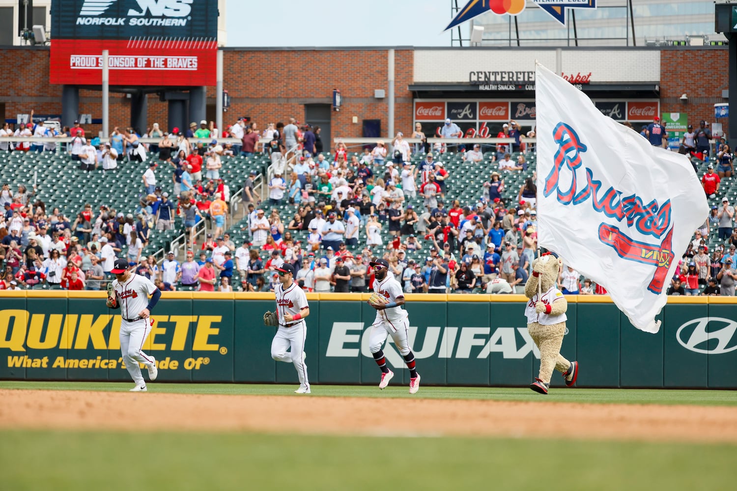 Braves outfielders run as Braves mascot the Blooper follows after the Braves swept the Minnesota Twins at Truist Park on Sunday, April 20, 2025, in Atlanta. 
(Miguel Martinez/ AJC)