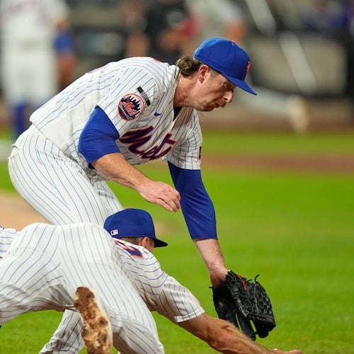 New York Mets pitcher Nolan McLean, top, collides with first baseman Jared Young as they chase a ball during the sixth inning of a baseball game against the Philadelphia Phillies, Thursday, Sept. 17, 2026, in New York. (AP Photo/Seth Wenig)