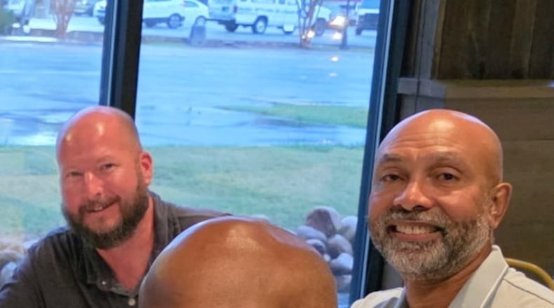 Ernie Strauss (left), a financial executive, and Ron Wakefield, an official with the state, share a common bond and dinner. They meet with others who are or have battled prostate cancer. The monthly gatherings are an extension of their support group meetings on a topic men generally don't want to talk about, including the treatment side effect of erectile dysfunction. (Courtesy Northside Hospital Atlanta)