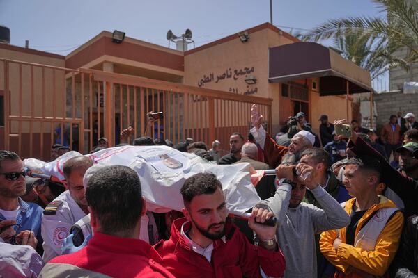 Mourners carry the bodies of 8 Red Crescent emergency responders, recovered in Rafah a week after an Israeli attack, as they are transported for burial from a hospital in Deir al-Balah, Gaza Strip, on Monday, March 31, 2025. (AP Photo/Abdel Kareem Hana)