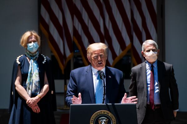 In this 2020 photo, then-White House coronavirus response coordinator Deborah Birx, left, and former National Institute of Allergy and Infectious Diseases Director Anthony S. Fauci, listen as former president Donald Trump speaks. A new report is critical of Trump's coronavirus response. (Jabin Botsford/The Washington Post)