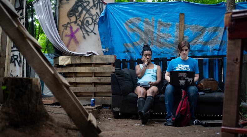 Tracy Woodard, right, speaks to Yamesha Carr about her housing application on May 17, 2024. Woodard works with InTown Cares, an advocacy group serving people experiencing homelessness in metro Atlanta. (Ben Hendren for the Atlanta Journal Constitution)