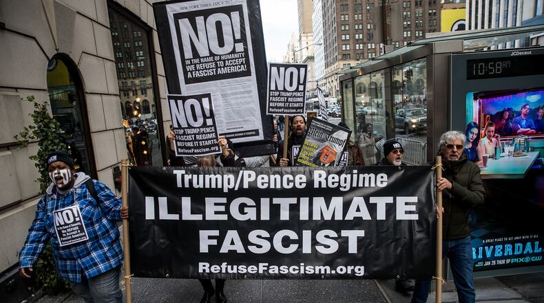 NEW YORK, NY - JANUARY 11: A small group of anti-Donald Trump protestors marches on 5th Avenue toward Trump Tower, January 11, 2017 in New York City. On Wednesday morning, Trump is having his first press conference since winning the election. (Photo by Drew Angerer/Getty Images)