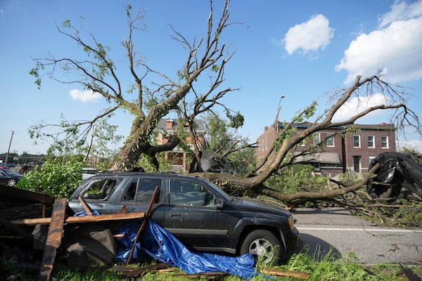 A large tree blocks a road after a severe storm moved through Friday, May 16, 2025, in St. Louis. (AP Photo/Jeff Roberson)