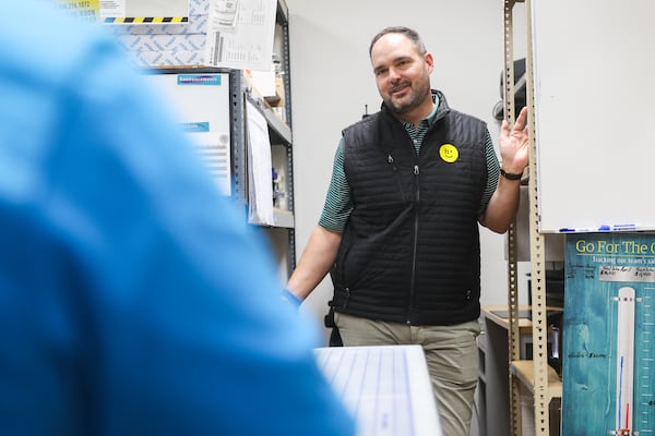 Joe McKinnie, senior VP of sales & business development at Happy Returns, talks with a colleague at a UPS Store in Marietta, on Tuesday, April 21, 2026. (Abbey Cutrer/AJC)