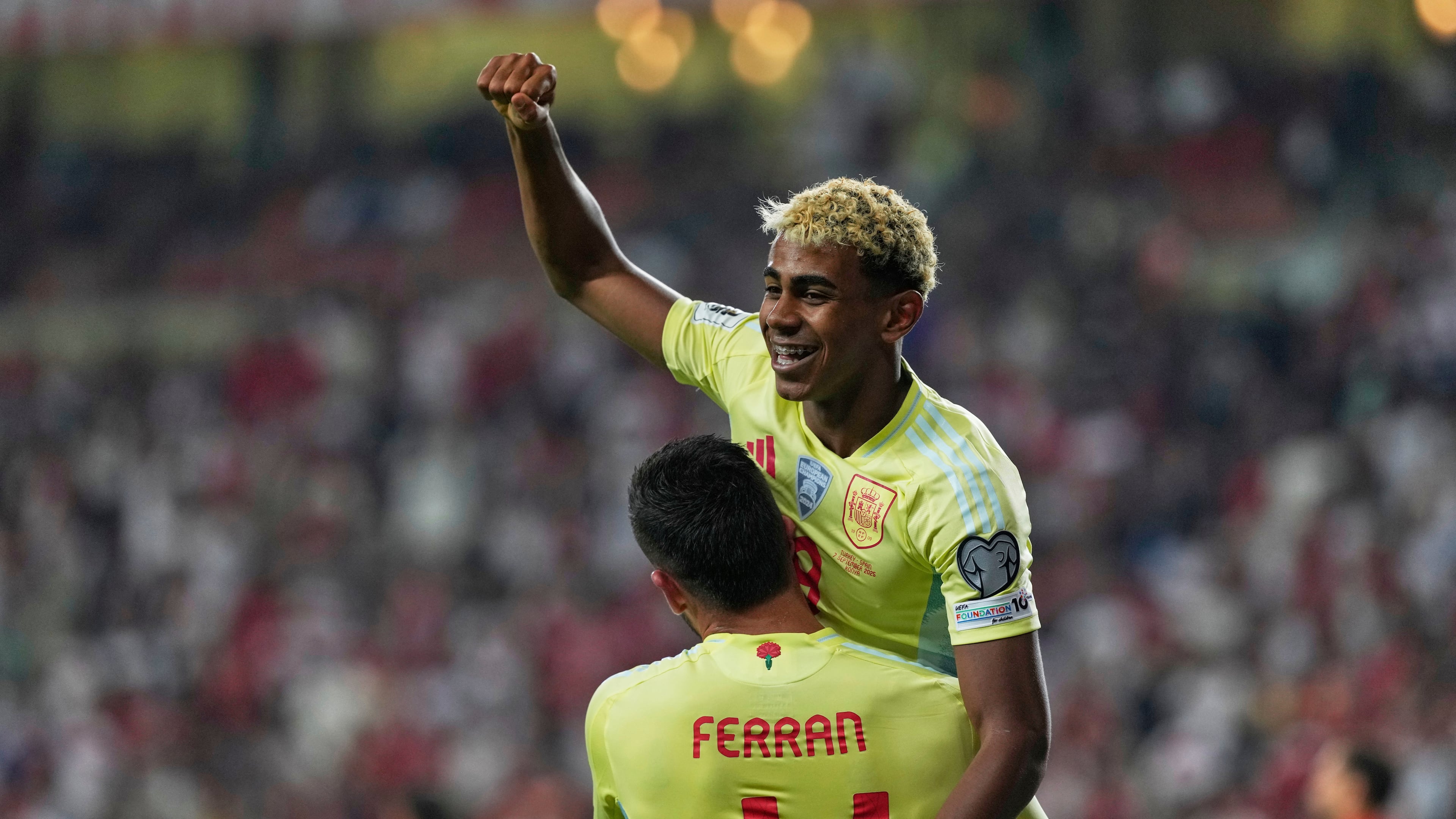 Spain's Ferran Torres, bottom, is congratulated by Lamine Yamal after scoring his side's 4th goal during a World Cup qualifying round Group E soccer match between Turkey and Spain at Konya Buyuksehir stadium, in Konya, Turkey, Sunday, Sept. 7, 2025. (AP Photo/Khalil Hamra)
