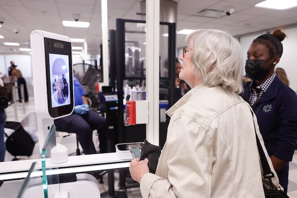 Rebecca Lind gets her face scanned in the CLEAR Plus line at Hartsfield-Jackson International Airport on Monday, Aug. 18, 2025. The new expedited screening process allows CLEAR members to use facial recognition to bypass standard TSA checkpoints. (Natrice Miller/ AJC)