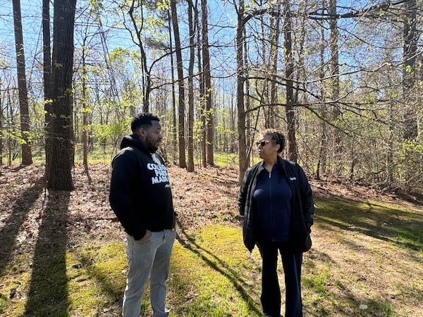 College Park resident Mose James IV is in the backyard of Carmen Miller's property. Her land is steps from where NextEra plans to build a battery storage facility on the 62-acre site. (Adrianne Murchison)