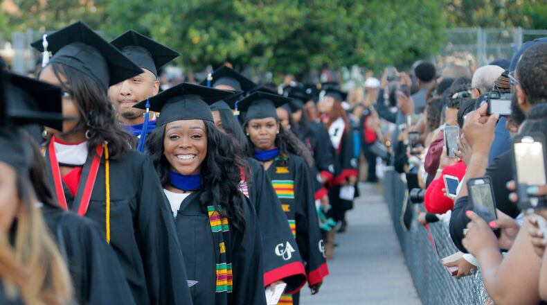5/22/17 - Atlanta - Graduates enter the stadium during the processional. Clark Atlanta University's Panther Stadium was the site of their 28th annual Commencement. Businessman William Pickard gave the commencement address. Rev. Jesse Jackson, who received an honorary degree also spoke. Panther Stadium, BOB ANDRES /BANDRES@AJC.COM
