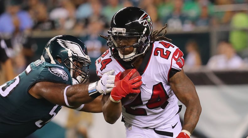 Falcons running back Devonta Freeman is tackled by the Eagles’ Brandon Graham in the season opener Sept. 6, 2018, at Lincoln Financial Field in Philadelphia.