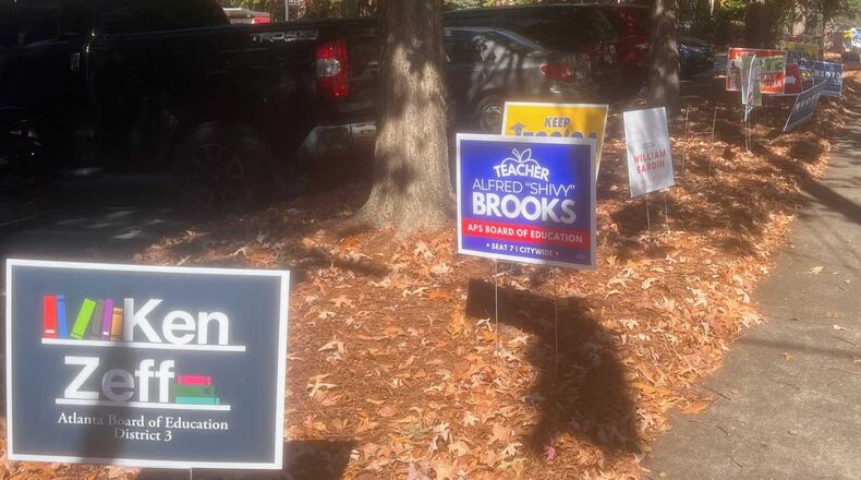 Campaign signs for various 2023 Atlanta school board candidates are lined up near an early voting location on Ponce de Leon Avenue in Midtown Atlanta. (Eric Stirgus / eric.stirgus@ajc.com)