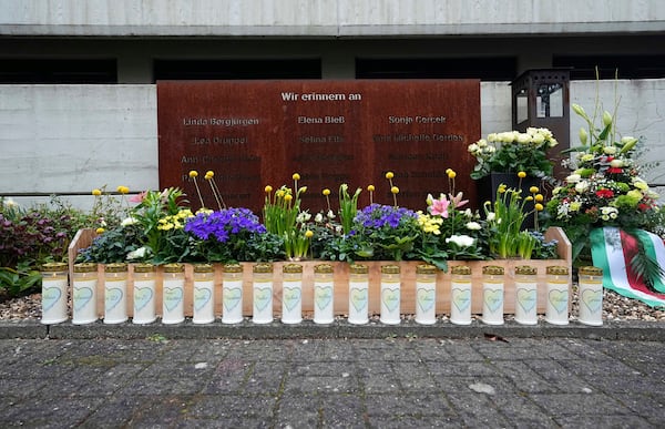Candles burn at the schoolyard of the Joseph-Koenig high school in Haltern, Germany, ten years after 16 pupils and two teachers of the school died in the Germanwings crash in the French Alps, Monday, March 24, 2025. (AP Photo/Martin Meissner)