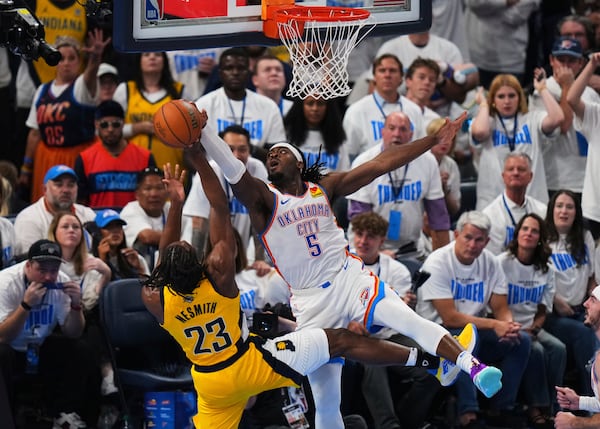 Oklahoma City Thunder guard Luguentz Dort (5) blocks a shot by Indiana Pacers forward Aaron Nesmith (23) during the second half of Game 1 of the NBA Finals basketball series Thursday, June 5, 2025, in Oklahoma City. (AP Photo/Nate Billings)