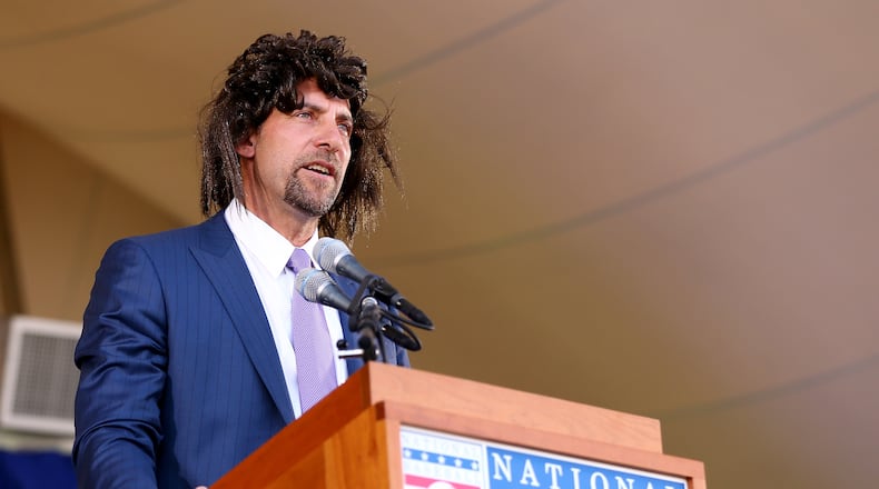 John Smoltz tries to relive his early days with hair as he speaks wearing a wig during the Hall of Fame induction ceremony for the Baseball Hall of Fame in Cooperstown, N.Y., on Sunday. Smoltz was inducted with Pedro Martinez,Craig Biggio and Randy Johnson. (Elsa/Getty Images)