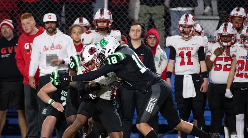 Gainesville's Darius Cannon is tackled by Roswell's Lawson Stargel during Friday's state semifinal matchup played at McEachern High in Powder Springs. (Jamie Spaar/For the AJC)