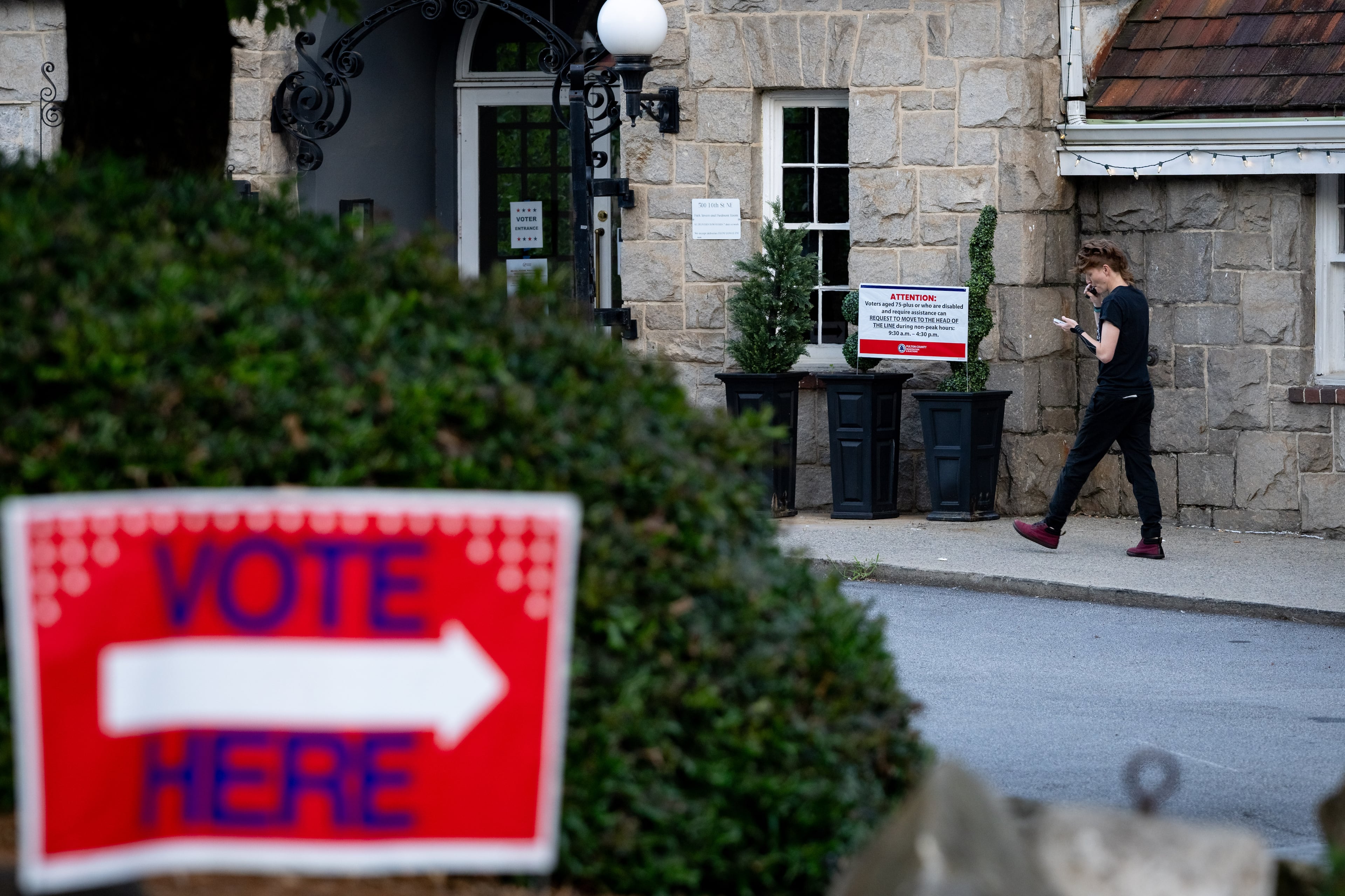 A woman walks into the Park Tavern voting precinct to vote in the Georgia Public Service Commission runoff election on Tuesday, July 15, 2025. It’s unusual for a regulatory race to become a proxy for Georgia’s broader political divide, but this one has. (Ben Hendren for the AJC)