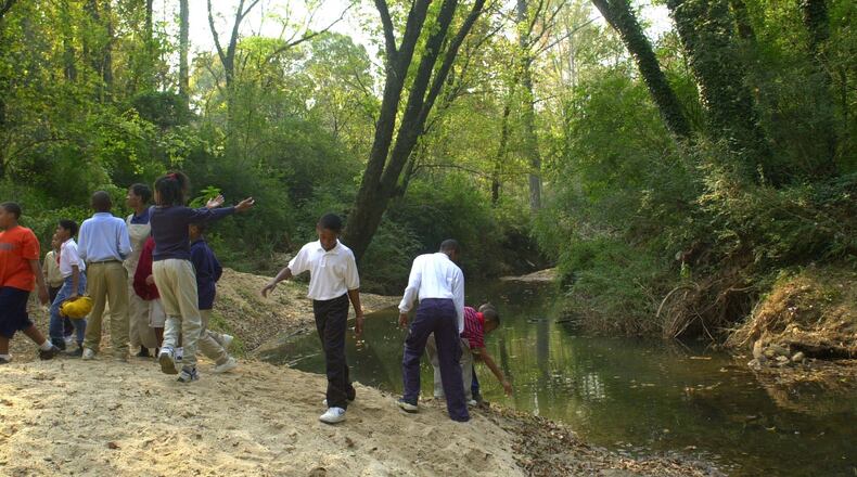 001026 ATLANTA -Utoy Creek behind Beecher Hills Elemetary School - In recognition of Georgia Clean Water Month, the City of Atlanta installs stream protection signs after the ceremony- the school children enjoy the creek. (NICK ARROYO/AJC staff)