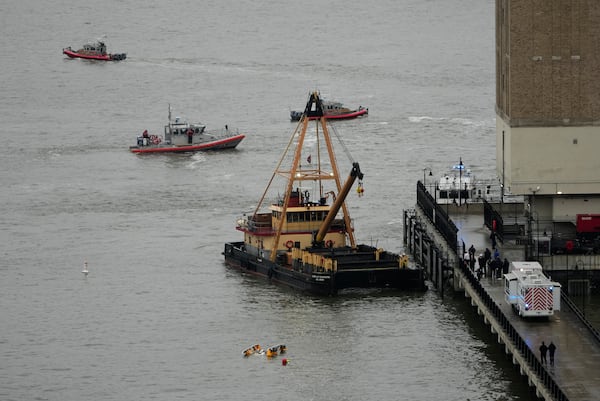 FILE - A crane vessel arrives at the scene where a helicopter crashed into the Hudson River, Thursday, April 10, 2025, in Jersey City, N.J. (AP Photo/Seth Wenig, File)