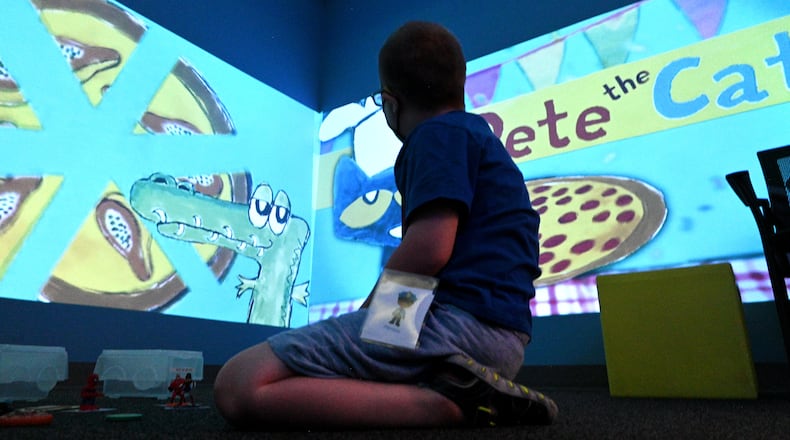 July 12 , 2022 Tucker - A summer camp participant plays and learns using technology in sensory room during a summer camp for children with special needs at Lekotek of Georgia in Tucker on Tuesday, July 12, 2022. Children with and without disabilities play and learn together in an environment that facilitates success. (Hyosub Shin / Hyosub.Shin@ajc.com)