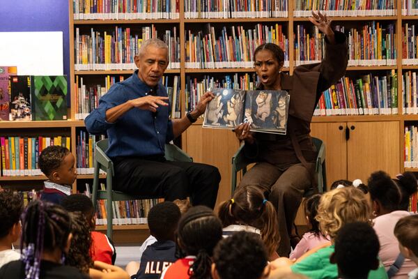 Former President Barack Obama and former first lady Michelle Obama read “Where the Wild Things Are” to children inside the Obama Presidential Center’s Chicago Public Library branch on Friday, June 19, 2026. (Ashlee Rezin/AP Pool)