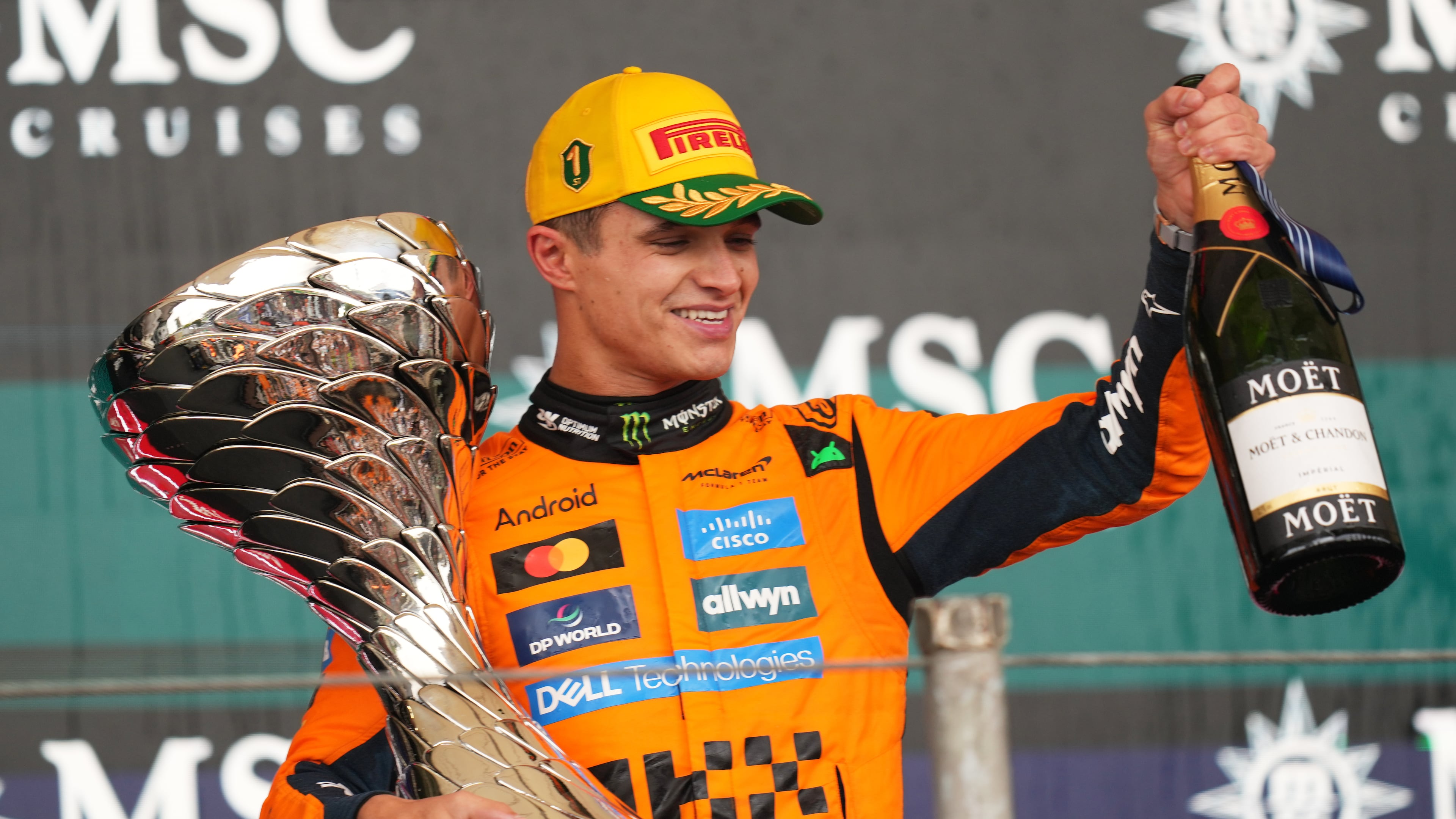McLaren driver Lando Norris of Britain celebrates on the podium his first place in the Brazilian Formula One Grand Prix at the Interlagos race track in Sao Paulo, Sunday, Nov. 9, 2025. (AP Photo/Andre Penner)