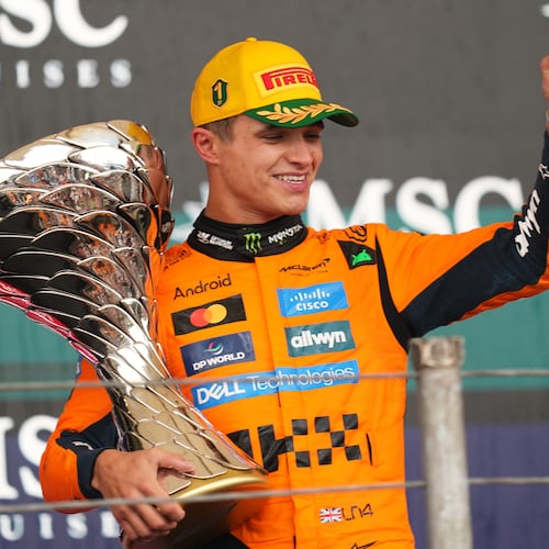 McLaren driver Lando Norris of Britain celebrates on the podium his first place in the Brazilian Formula One Grand Prix at the Interlagos race track in Sao Paulo, Sunday, Nov. 9, 2025. (AP Photo/Andre Penner)