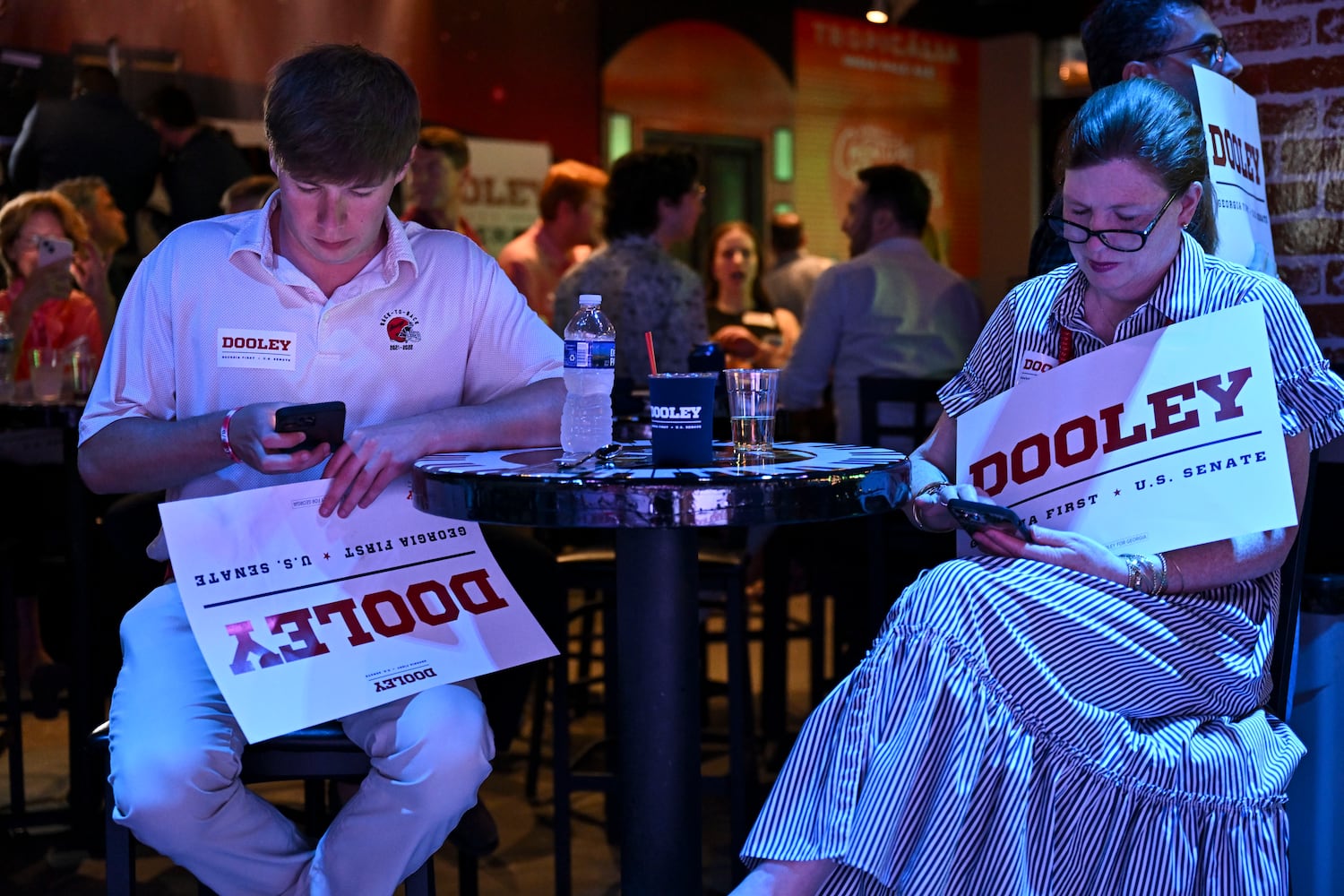 Allen Gruehn and his mother, Allison Gruehn, wait for Georgia GOP gubernatorial candidate Derek Dooley at his election night party at Park Bench at the Battery during the 2026 Georgia primary elections Tuesday, May 19, 2026, in Atlanta. (Daniel Varnado for the AJC)