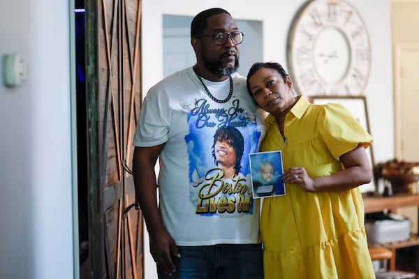 Ramonne and Terrica Thomas hold on to memories of their son, Boston Thomas, as they seek answers about his death in a PIT maneuver by a Cobb County police officer. (Miguel Martinez/AJC)