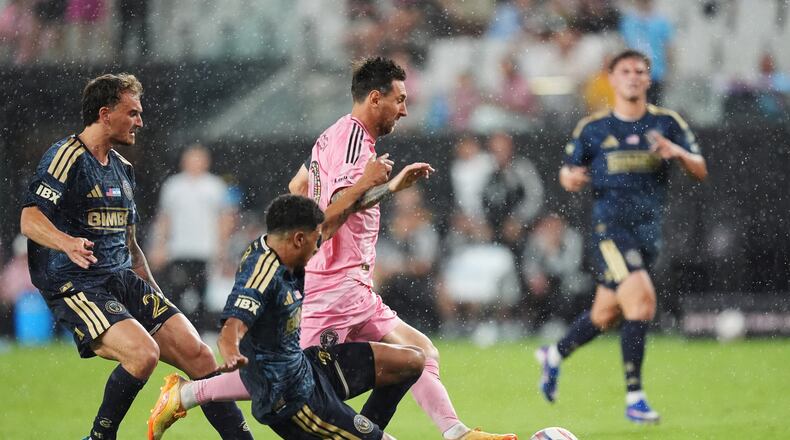 Inter Miami forward Lionel Messi, center, drives forward under pressure from Philadelphia Union forward Augustin Anello, left, and defender Nathan Harriel, bottom, during the second half of an MLS soccer match, Sunday, May 24, 2026, in Miami. (AP Photo/Rebecca Blackwell)
