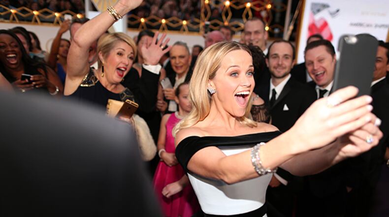 Actress Reese Witherspoon takes a selfie while attending this year's Academy Awards. (Photo by Christopher Polk/Getty Images)