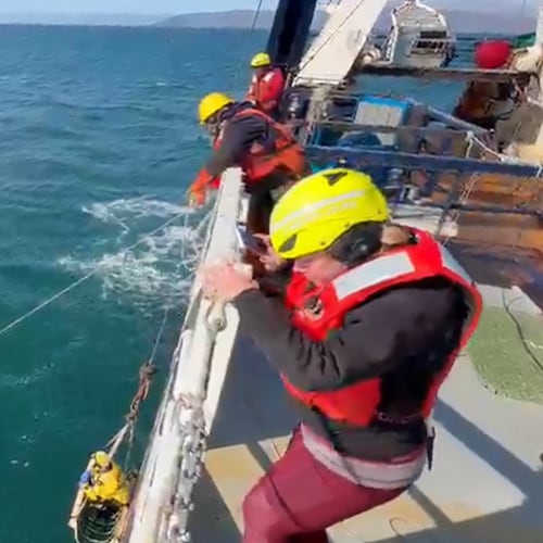 This image taken from video provided by Carlos Alexis Escartin shows a teenager being rescued by a fishing vessel Monday, Sept. 7, 2026, in the Bering Sea near St. Lawrence Island, Alaska. (Carlos Alexis Escartin via AP)