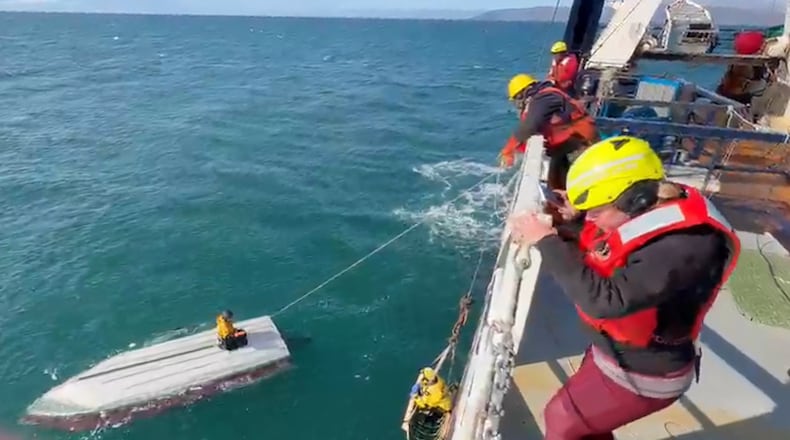 This image taken from video provided by Carlos Alexis Escartin shows a teenager being rescued by a fishing vessel Monday, Sept. 7, 2026, in the Bering Sea near St. Lawrence Island, Alaska. (Carlos Alexis Escartin via AP)