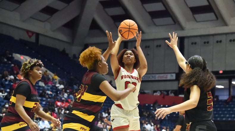 March 10, 2022 Macon - Woodward Academy's Sydney Bowles (0) shoots over Forest Park's Makayla Arnold (34) during the 2022 GHSA State Basketball Class AAAAA Girls Championship game at the Macon Centreplex in Macon on Thursday, March 10, 2022. (Hyosub Shin / Hyosub.Shin@ajc.com)