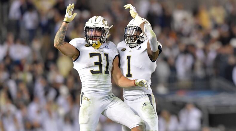 November 10, 2018 Atlanta - Georgia Tech Nathan Cottrell (31) and Qua Searcy (1) celebrate their victory at the end of 4th quarter at Bobby Dodd Stadium on Saturday, November 10, 2018. Georgia Tech won 27 - 21 over the Miami. HYOSUB SHIN / HSHIN@AJC.COM