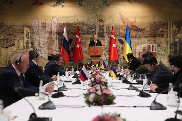 FILE - In this photo provided by the Turkish Presidency, Turkish President Recep Tayyip Erdogan, center, gives a speech to welcome the Russian, left, and Ukrainian delegations ahead of their talks in Istanbul, Turkey, on March 29, 2022. (Turkish Presidency via AP, File)