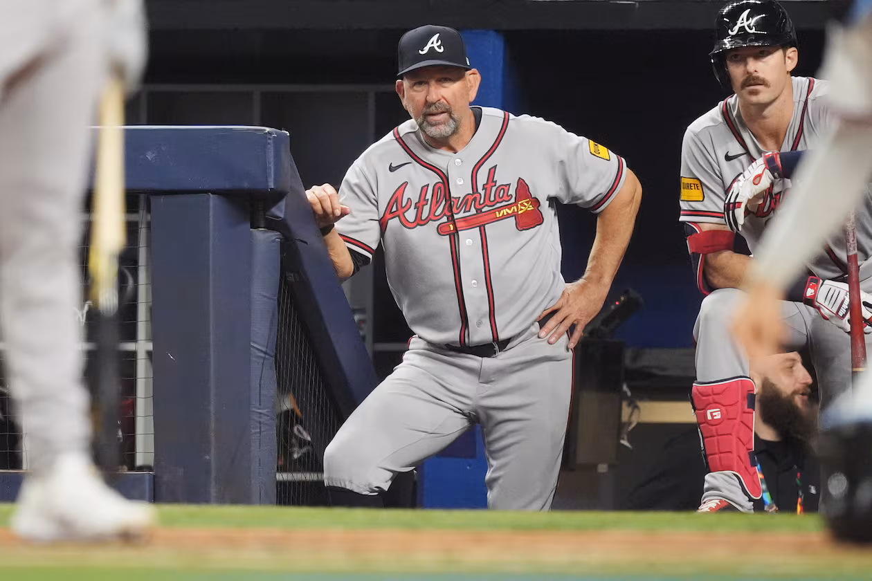 Braves manager Walt Weiss (center) watches his team during a game against the Marlins on May 18, 2026, in Miami. Weiss says communicating with players about lineup changes is key. (Rebecca Blackwell/AP)