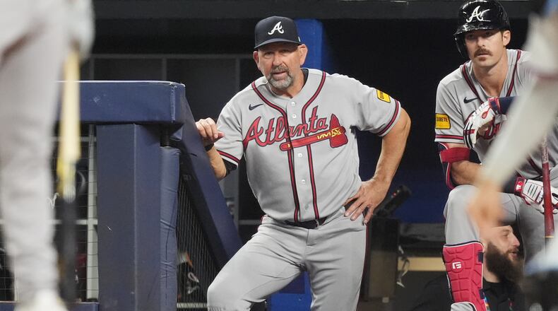 Braves manager Walt Weiss (center) watches his team during a game against the Marlins on May 18, 2026, in Miami. Weiss says communicating with players about lineup changes is key. (Rebecca Blackwell/AP)