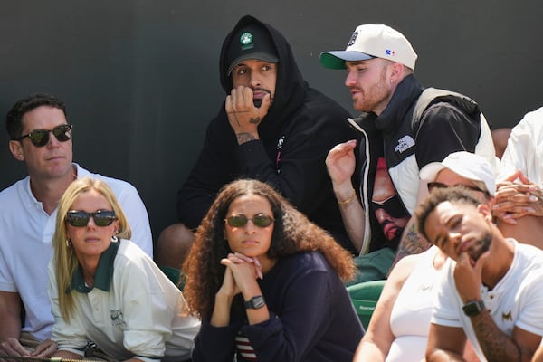 Australian tennis player Nick Kyrgios, top center, watches as Naomi Osaka of Japan plays Russia's Anastasia Pavlyuchenkova during a third round women's singles match at the Wimbledon Tennis Championships in London, Friday, July 4, 2025. (AP Photo/Alastair Grant)