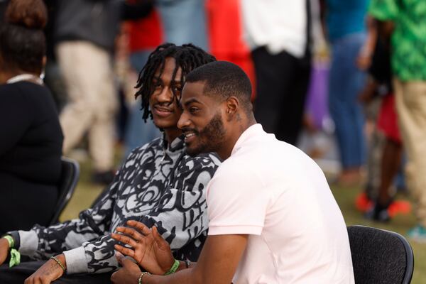 Ryder Wade (left) and Rico Wade Jr., sons of Organized Noize co-founder Rico Wade, attend the unveiling of a monument dedicated to the legacy of their father in East Point on Friday. (Natrice Miller/AJC)