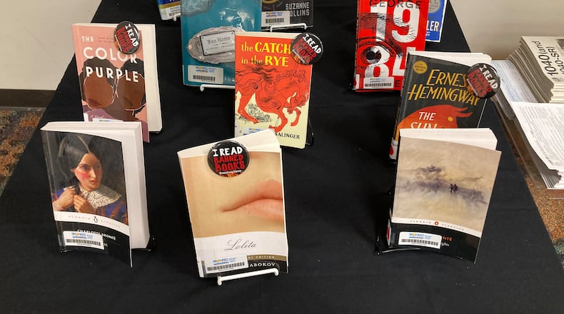 The "book sanctuary" table at the Fort Lauderdale Reading Center, a branch of the Broward County Library, on Tuesday, May 23, 2023. Identified by a sign explaining it was  "A Safe Place for Stories," the table had copies of 11 books, including “The Color Purple,” “The Catcher in the Rye,” “Catch-22,” “The Sun Also Rises” and “The Hunger Games.” (Anthony Man/South Florida Sun Sentinel/TNS)
