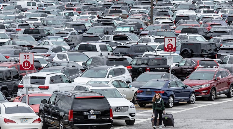 People walk through the South economy lot at Hartsfield-Jackson Atlanta International Airport on Thursday, Sept. 28, 2023. Hartsfield-Jackson plans to close the South economy lot on Oct. 23 to prepare for the construction of a new parking deck on the site. (Steve Schaefer/steve.schaefer@ajc.com)