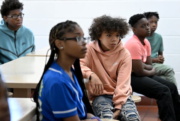 Students — including Jayden Burgess (center), 14 — listen to prison inmate Marcus Lawson at the Athens-Clarke County Correctional Institution. “I just keep coming back,” Burgess said. “That way I can keep doing better.” (Hyosub Shin/AJC)