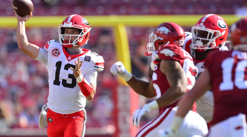 Georgia quarterback Stetson Bennett (13) unleashes one of this 29 passes during the Bulldogs' game against Arkansas in Fayetteville, Ark., on Saturday, Sept. 26, 2020. (Photo by Walt Beazley)